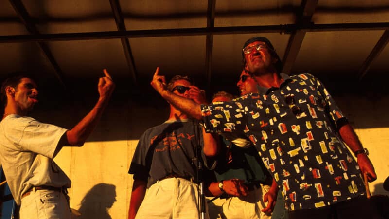 Eddie Jordan and Damon Hill gesture at each other onstage at the 1994 British GP