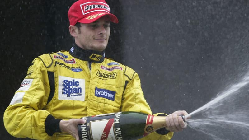 Giancarlo Fisichella Jordan celebrates on podium Brazilian GP trophy 2003