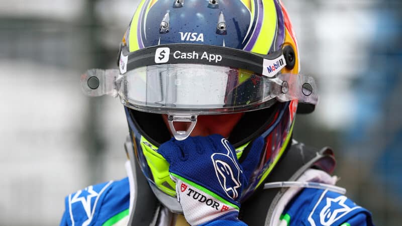 Isack Hadjar puts his hands to his helmet after crashing out of the 2025 f1 Australian Grand prix on the formation lap